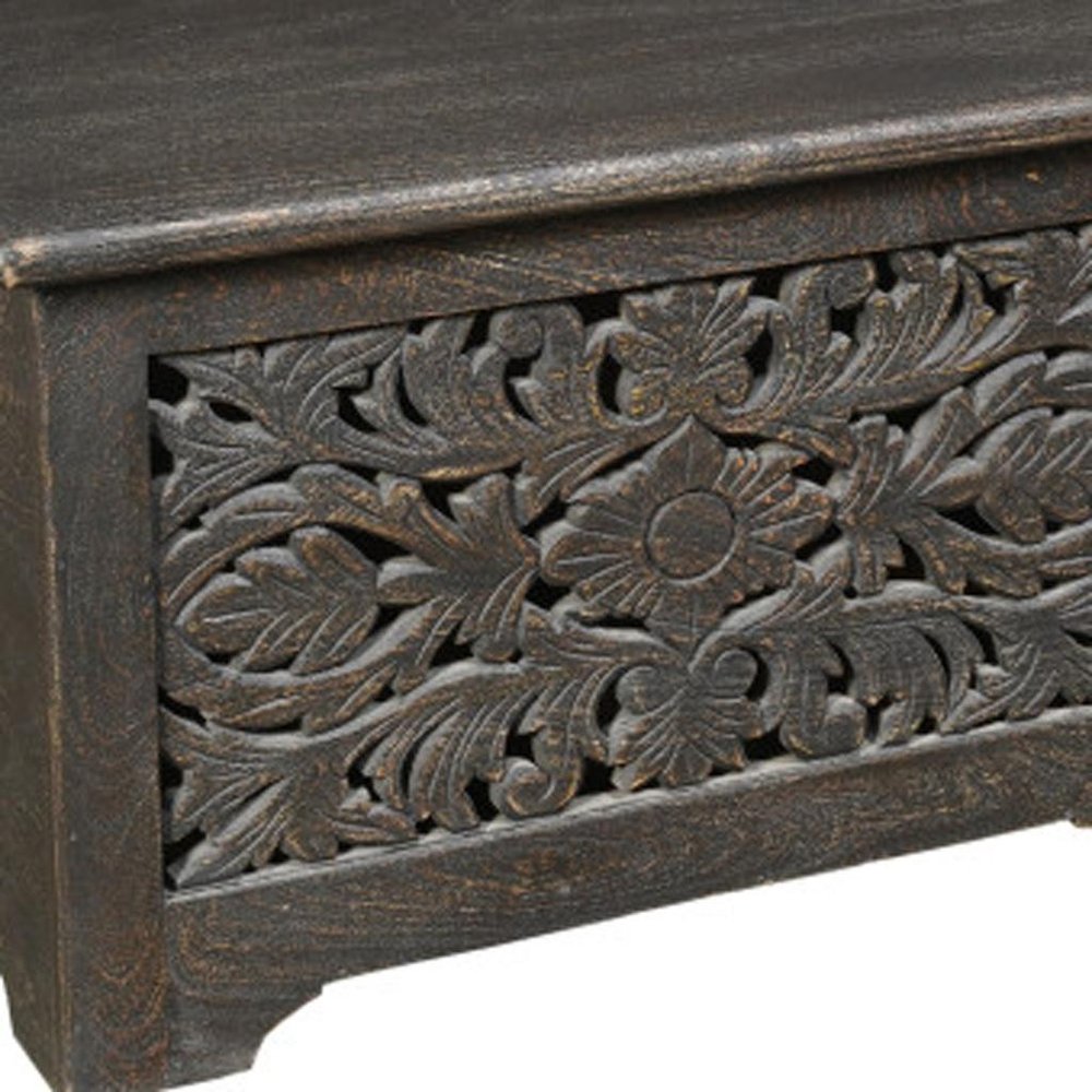 52" Black Solid Wood Floral Ottoman With Storage detail shot of the black wood finish.