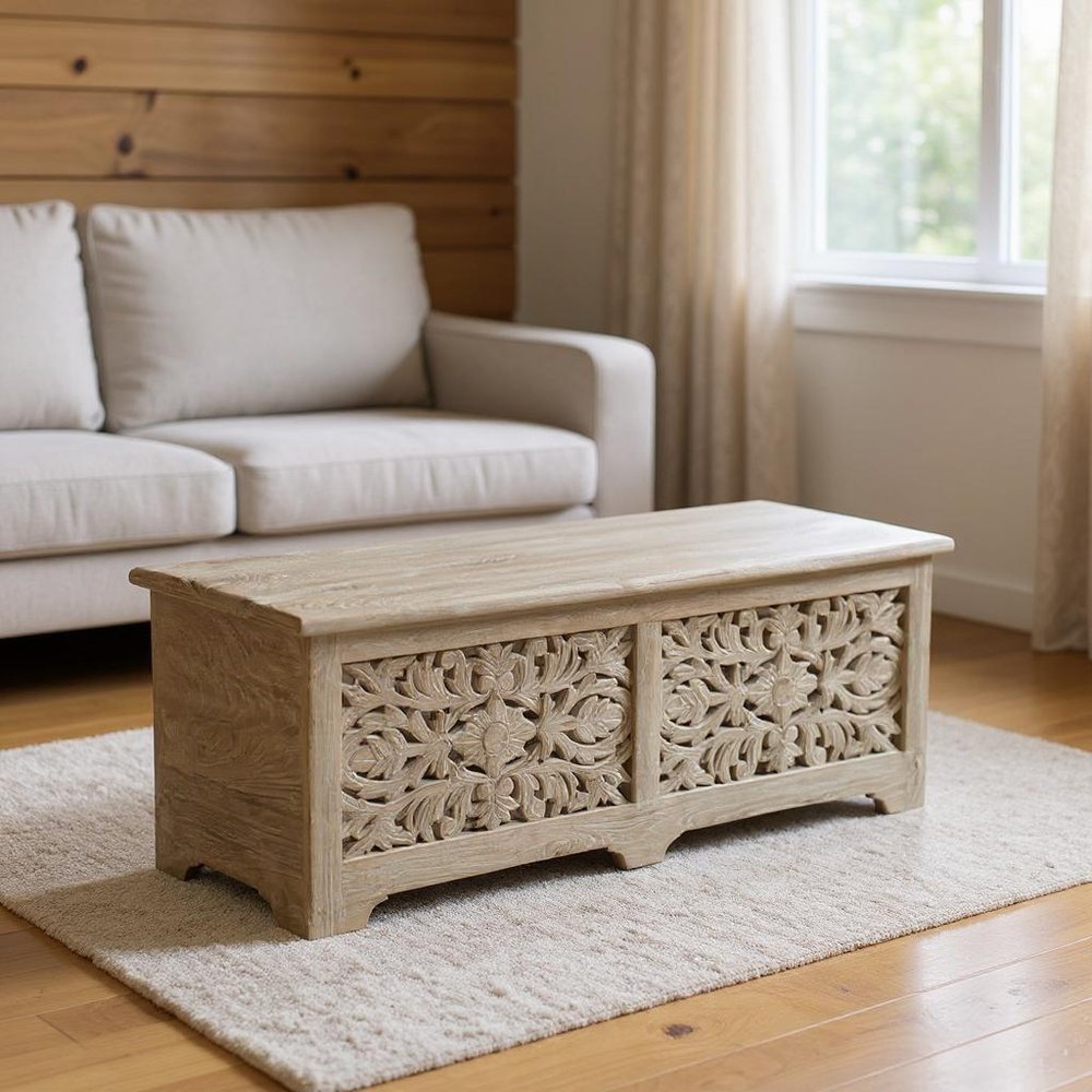52" Gray Solid Wood Floral Ottoman With Storage styled in a furnished interior with a dark brown wall on a wood floor.