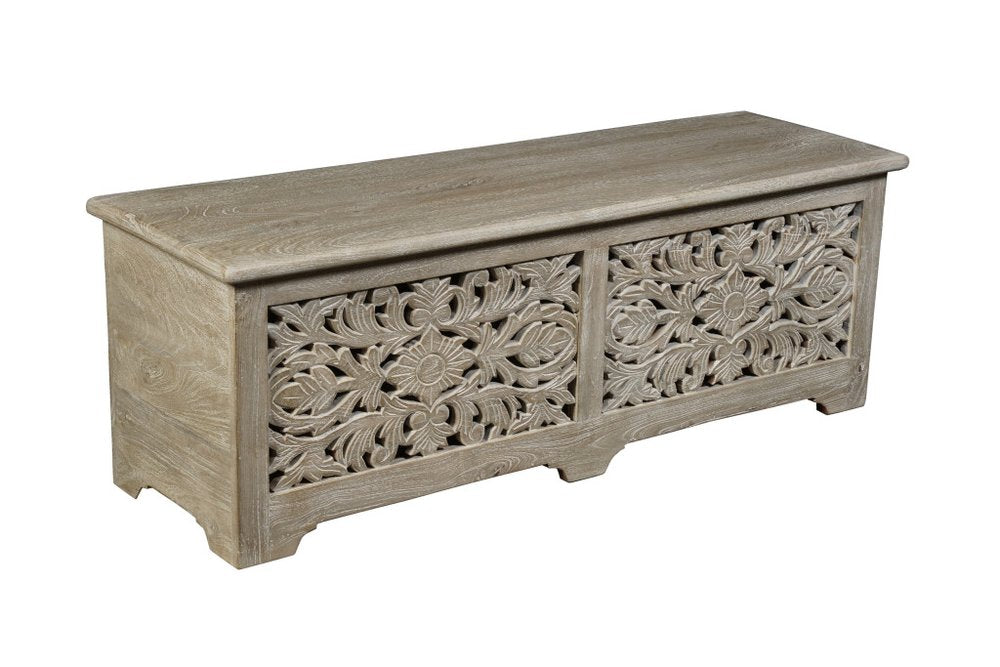 Gray distressed solid wood carved floral storage ottoman on a white background.