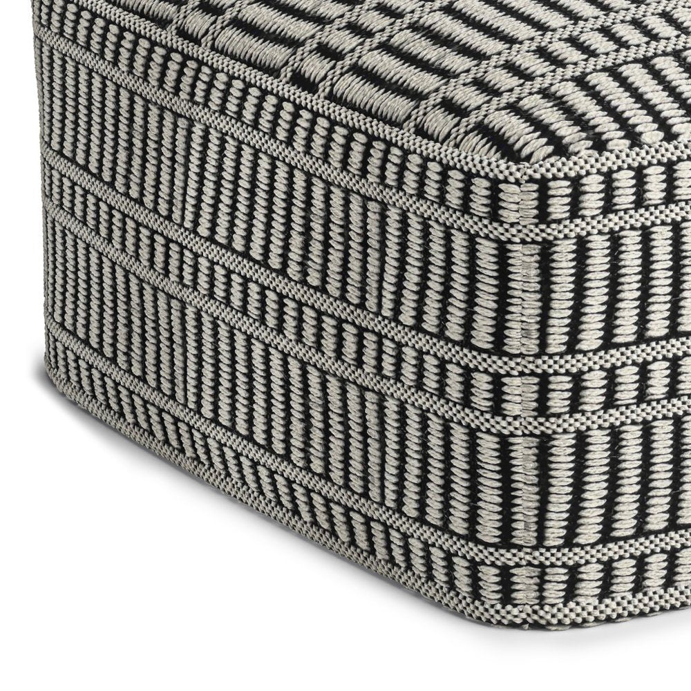 20" Black And White Polyester Geometric Outdoor Pouf Ottoman. Outdoor ottoman in black fabric.