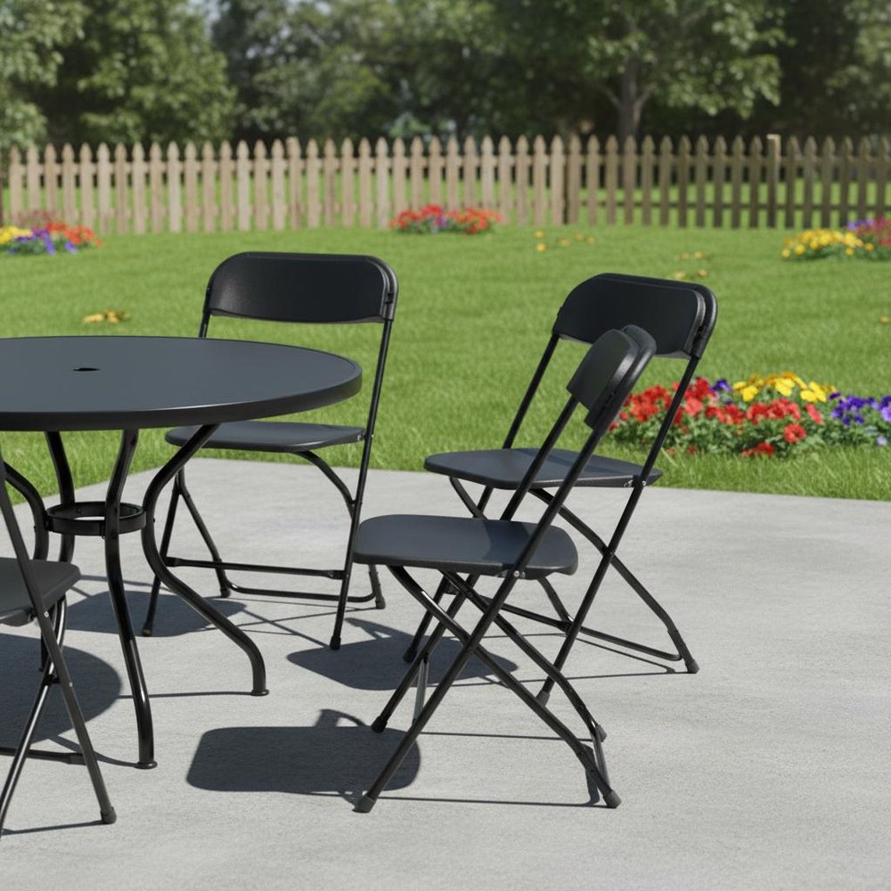 Set of Four Black Metal Outdoor Folding Stacking Dining Chairs in a home interior