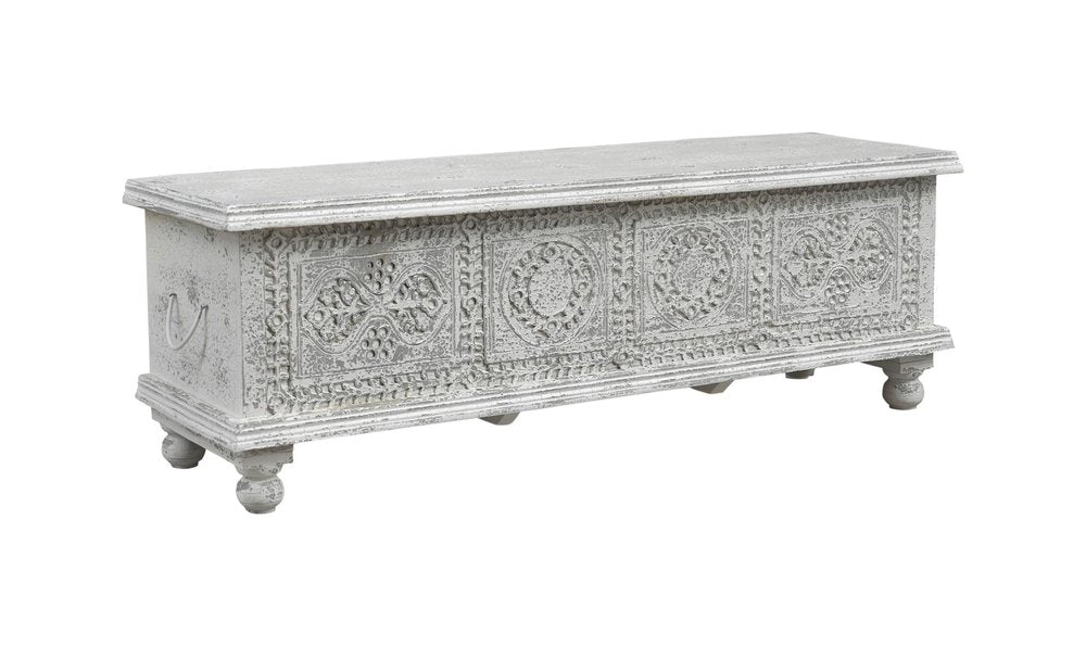 A white solid wood storage ottoman with carved medallion details and ball feet, isolated on a white background.