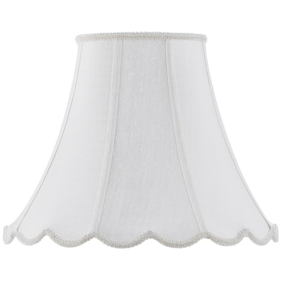 White linen bell lamp shade with decorative trim on the top and scalloped bottom edge against a white background.