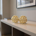 Set of Two Gold And Pearl Faux Crystal And Metal Decorative Orbs in a home interior