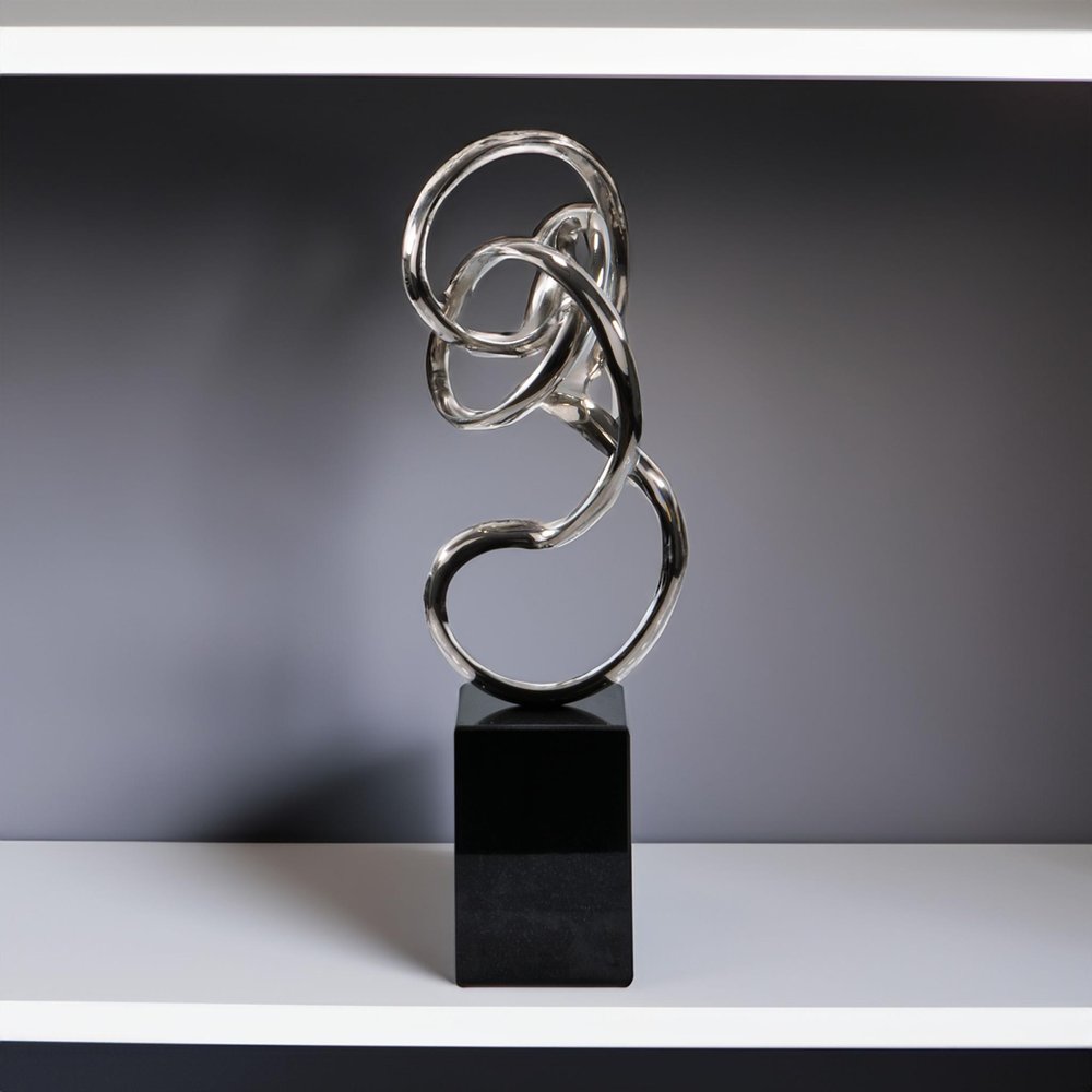 Close-up of 20" Silver And Black Aluminum And Marble Modern Abstract Tabletop Sculpture showing the silver metal texture.