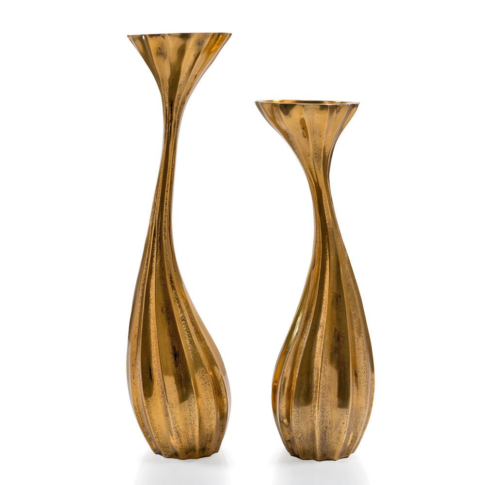 Set of two antiqued gold aluminum wavy faceted tabletop pillar candle holders on a white background.