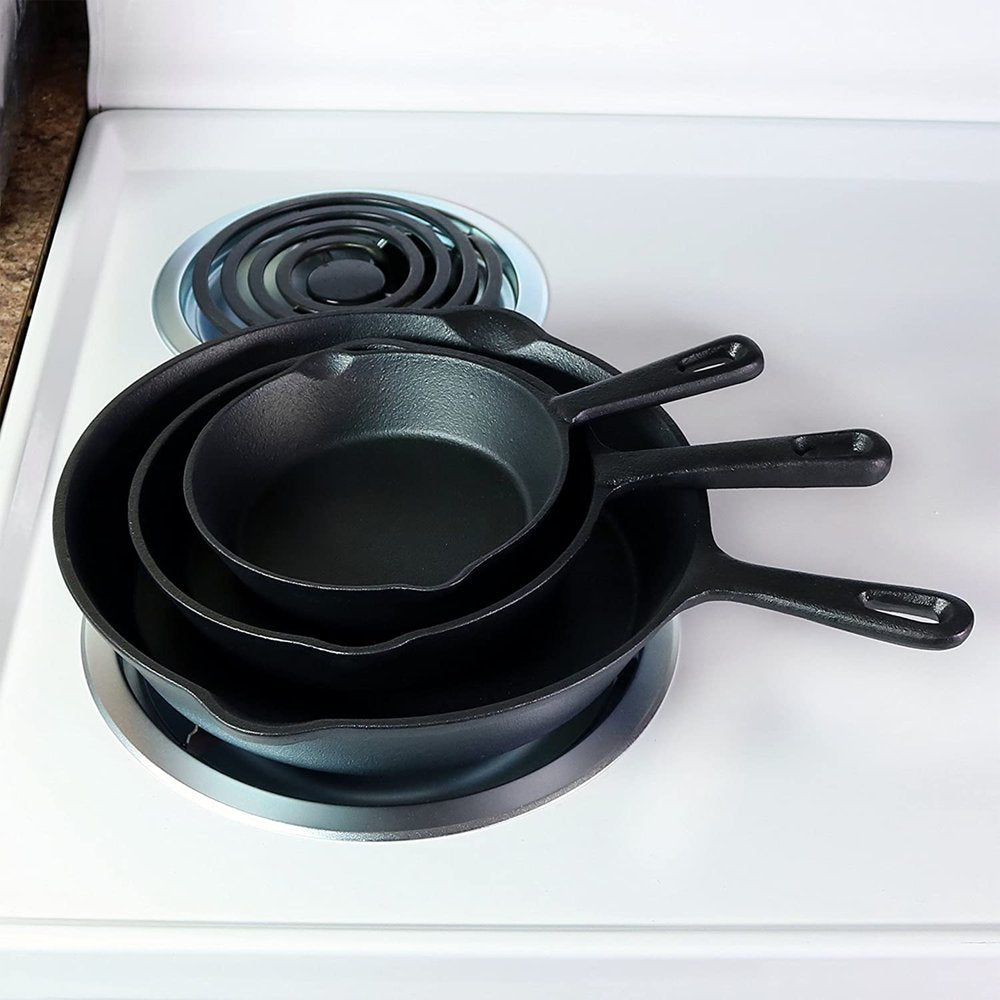 Set of Three Black Cast Iron Frying Pans on a white background