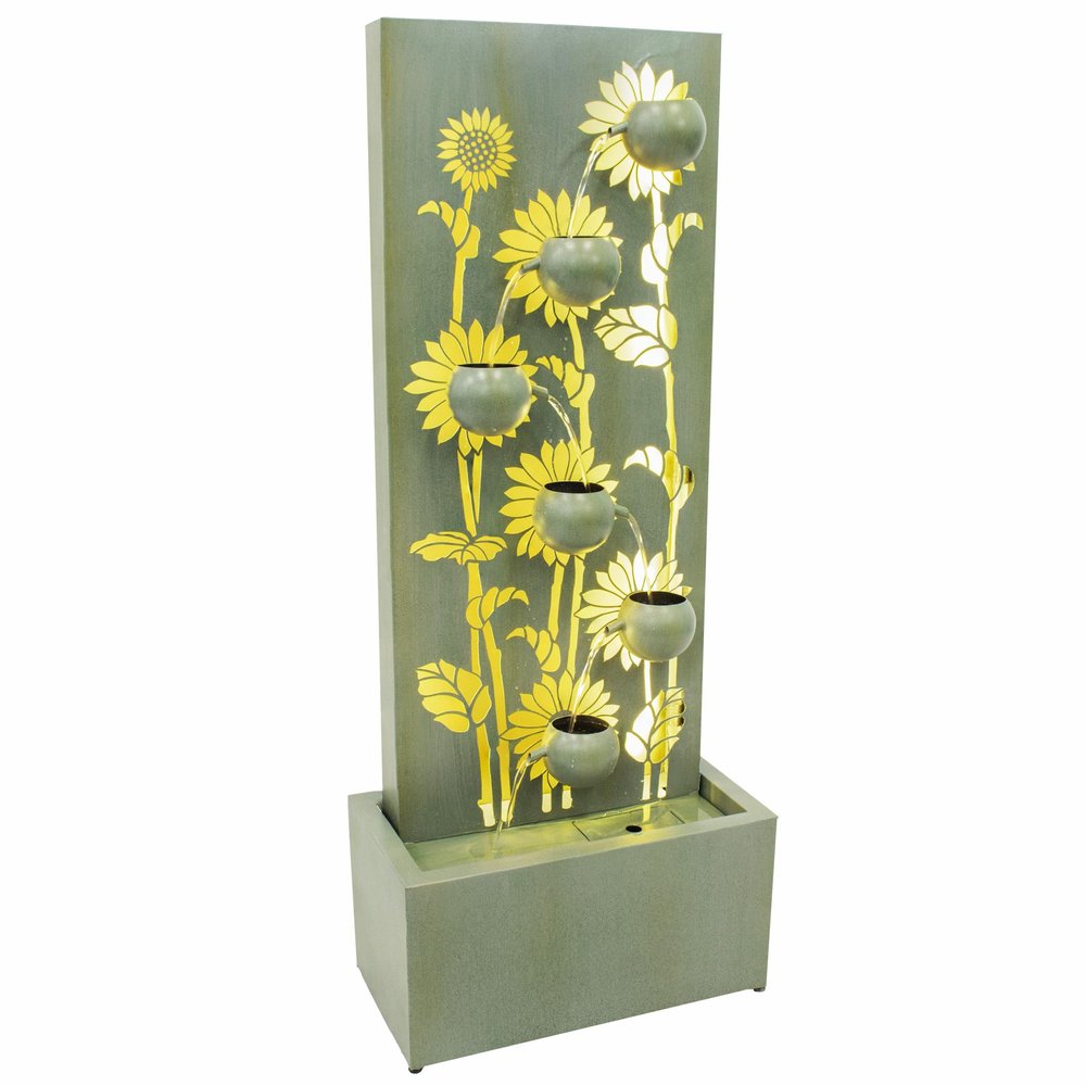 A tall, light green steel garden fountain with sunflower cutouts and cascading water, set against a white background.