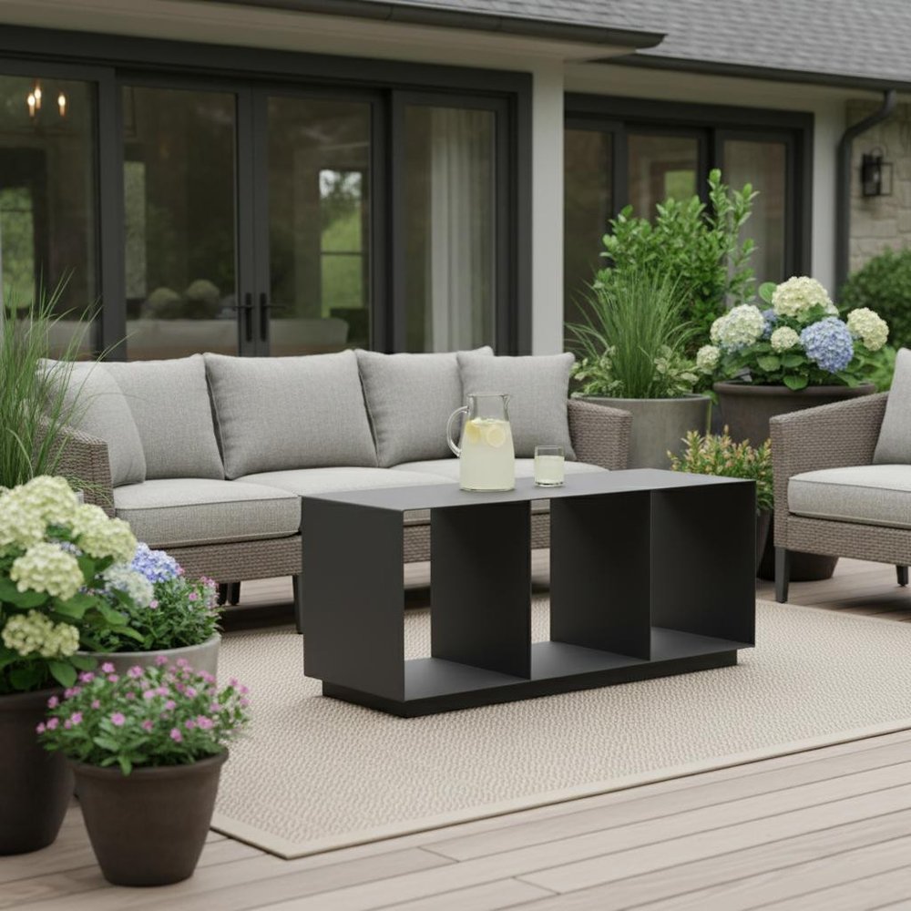 36" Charcoal Aluminum Outdoor Coffee Table shown outdoors on a tiled patio with greenery.