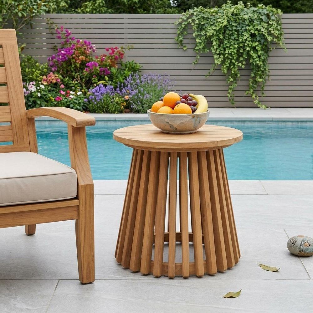 16" Natural Solid Wood Round Outdoor Side Table shown outdoors on a patio with greenery in tan wood.