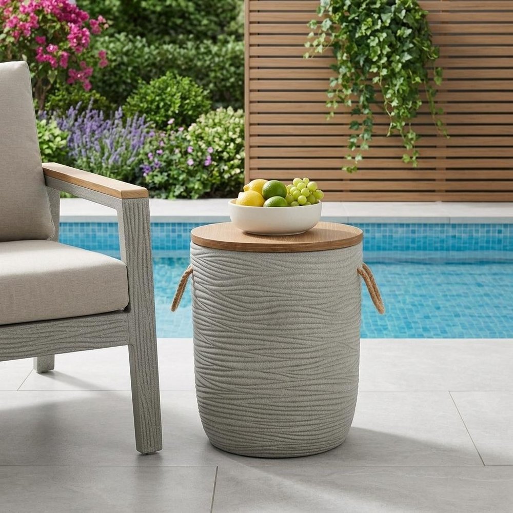 14" Natural and Gray Solid Wood and Faux Concrete Round Outdoor Side Table shown outdoors on a tiled patio with greenery.