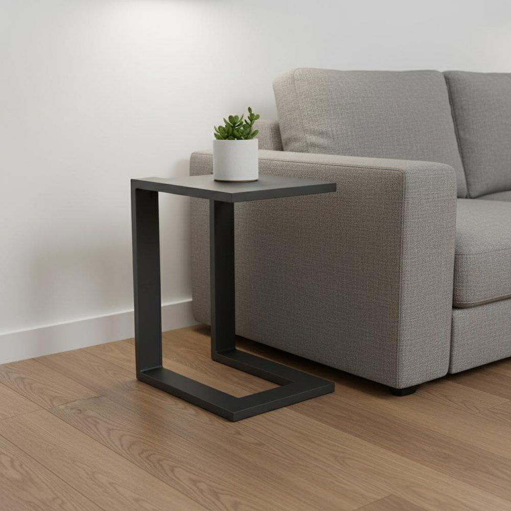 18" Black Aluminum Outdoor Side Table styled in a furnished interior with an off-white wall on a wood floor.