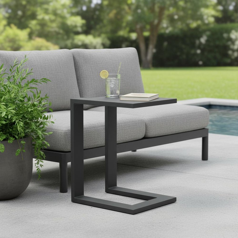 18" Black Aluminum Outdoor Side Table shown outdoors on a tiled patio with greenery.