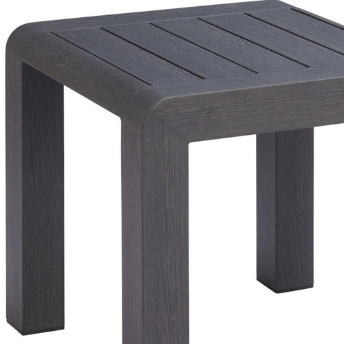 Close-up of a dark gray outdoor side table with a slatted top and square legs, set against a white background.