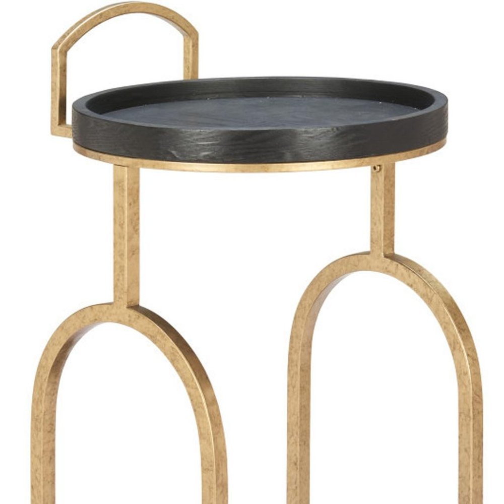 Round black and brass steel and solid wood distressed bar cart with arched legs on a white background.