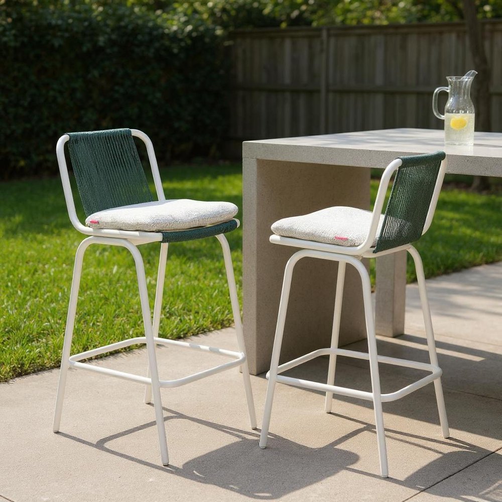Set of Two White and Green Woven Back And Aluminum Counter Height Bar Chairs in a home interior