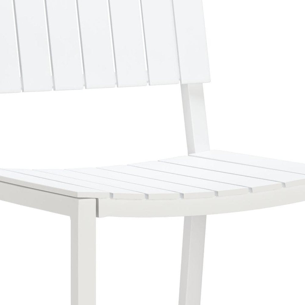 Close-up of a white aluminum outdoor bar height chair with slatted seat and back.