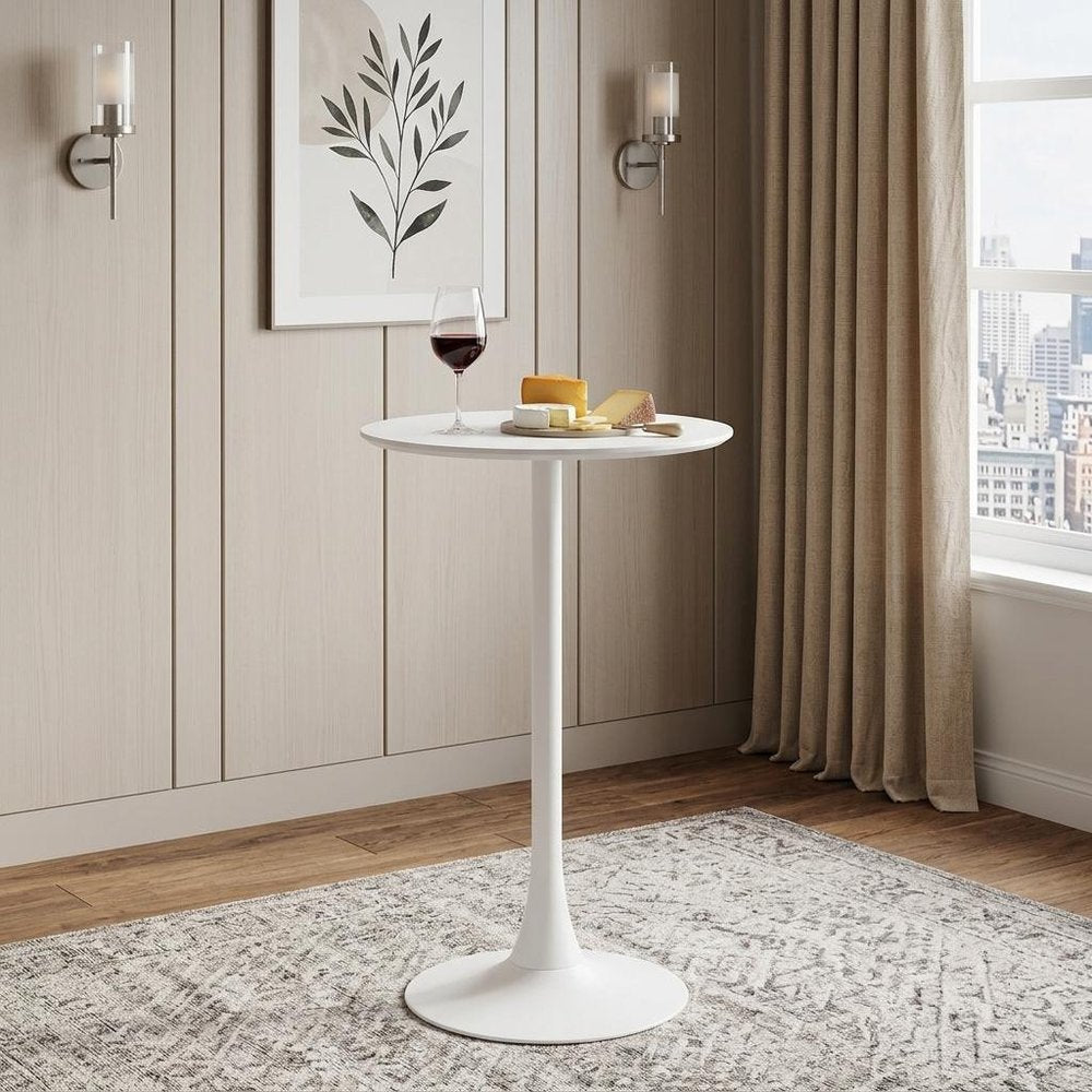 24" White Wood and Steel Rounded Bar Table styled in a furnished interior with a tan wall on a tiled floor.