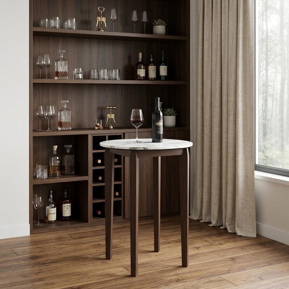 32" White and Brown Faux Marble and Solid Wood Rounded Bar Table styled in a furnished interior with a dark brown wall on a dark wood floor.