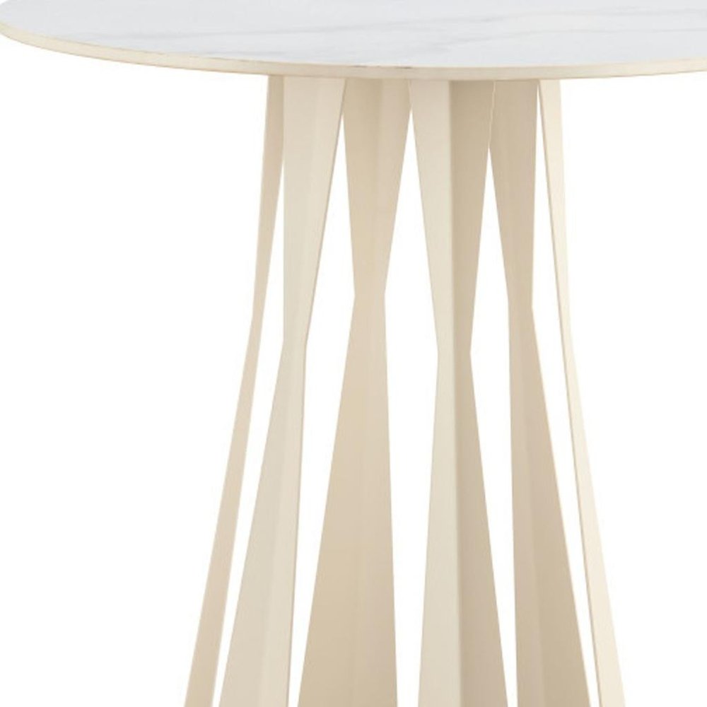 A close-up of a round white faux marble bar table with a beige steel base featuring a unique, faceted design against a white background.