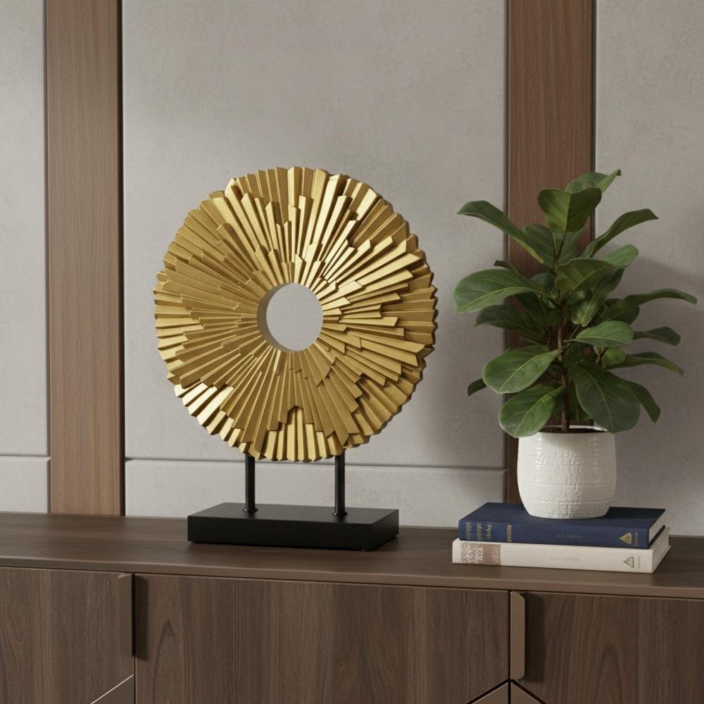 12" Gold Resin Sunflower Hand Painted Tabletop Sculpture styled in a furnished interior with a gray wall on a dark wood floor.