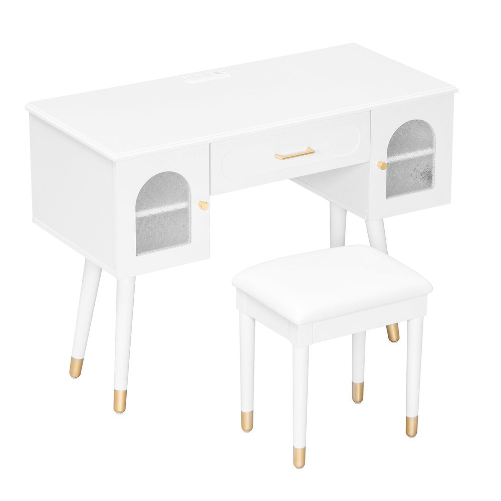 White wood vanity table with a drawer and two cabinet doors, and a matching white stool with gold accents, on a white background.