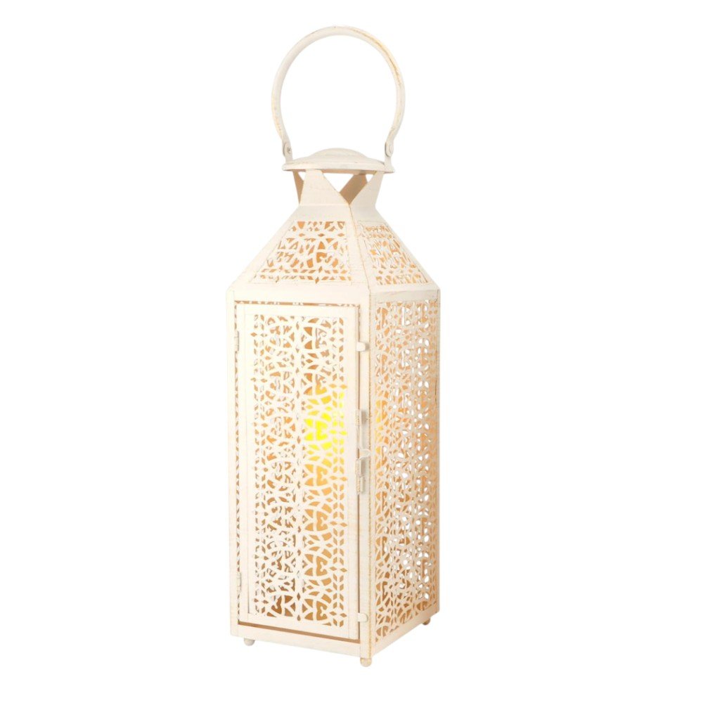 White filigree metal lantern with a yellow light inside, set against a white background.