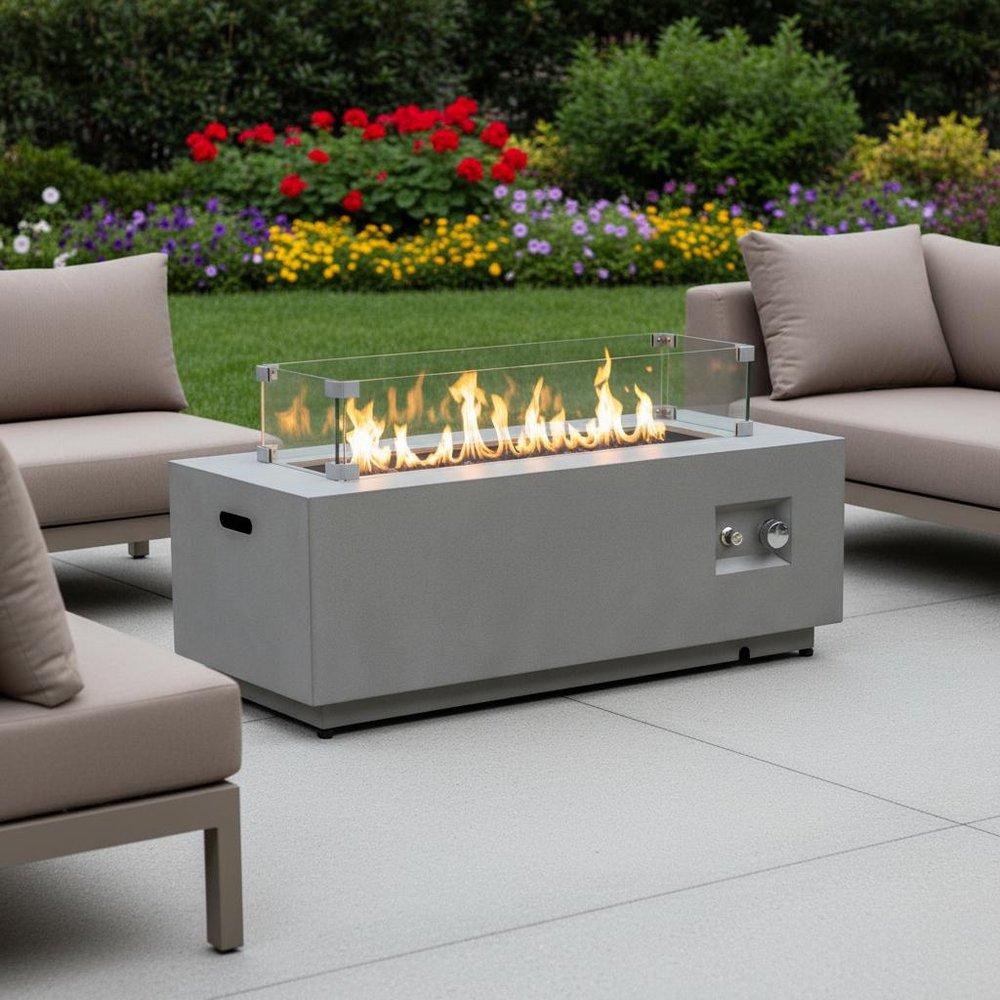 50000 BTU 42" Gray Steel Propane Rectangular Fire Pit With Cover shown outdoors on a tiled patio with greenery.