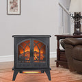 24" Black Carved Geometric Metal Electric Fireplace styled in a furnished interior with a light gray wall on a wood floor.