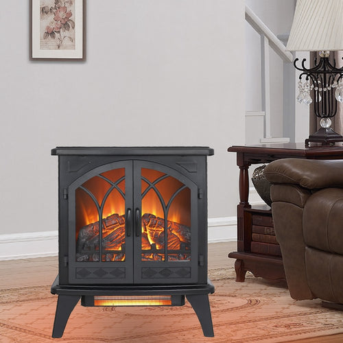 Black metal electric fireplace with glass doors and faux logs, set on a rug in a living room.