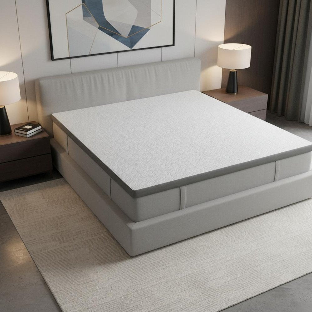 2" White Gel Memory Foam King Mattress Topper styled in a furnished interior with a light gray wall on a tiled floor.