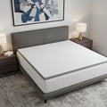3" White Gel Memory Foam California King Mattress Topper styled in a furnished interior with a light gray wall on a tiled floor.