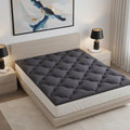 2" Dark Gray Cotton Full Double Mattress Topper styled in a furnished interior with a light gray wall on a wood floor in charcoal cotton.