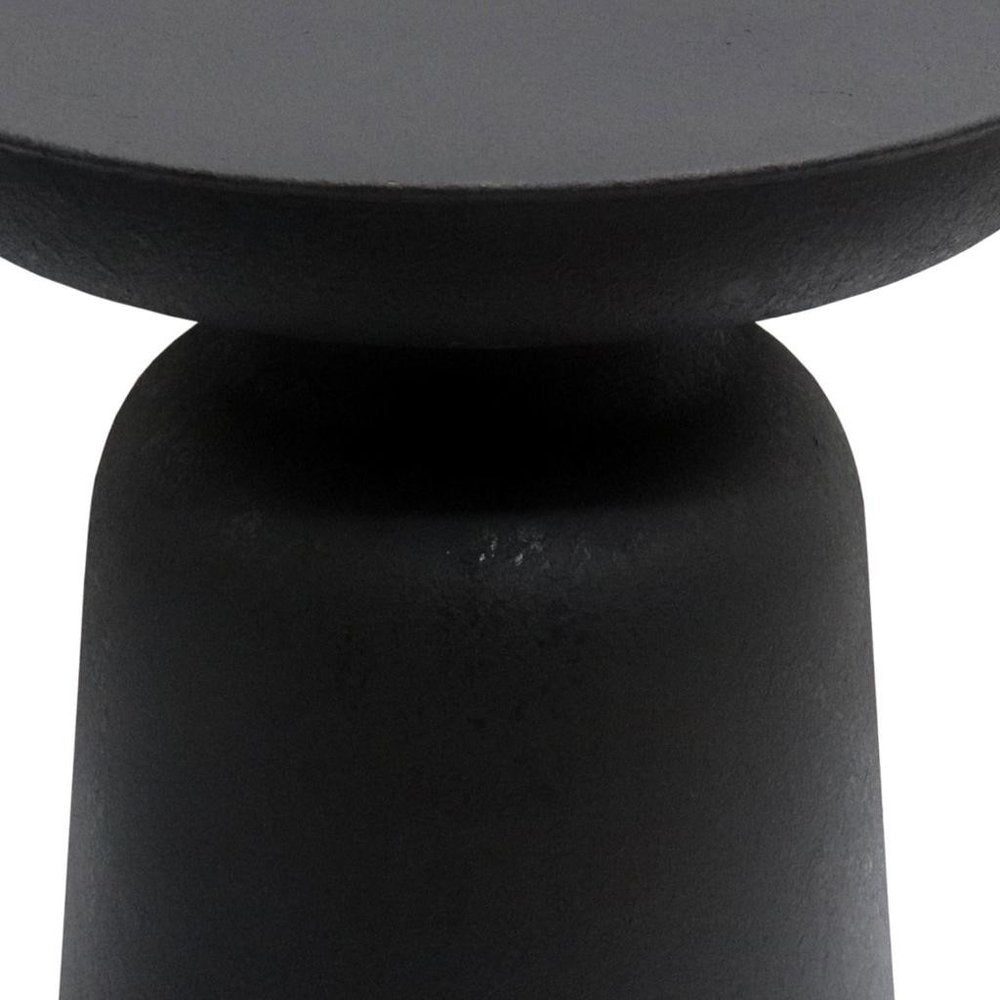 Close-up of a black, textured, solid furniture piece with a rounded top and base, isolated on a white background.