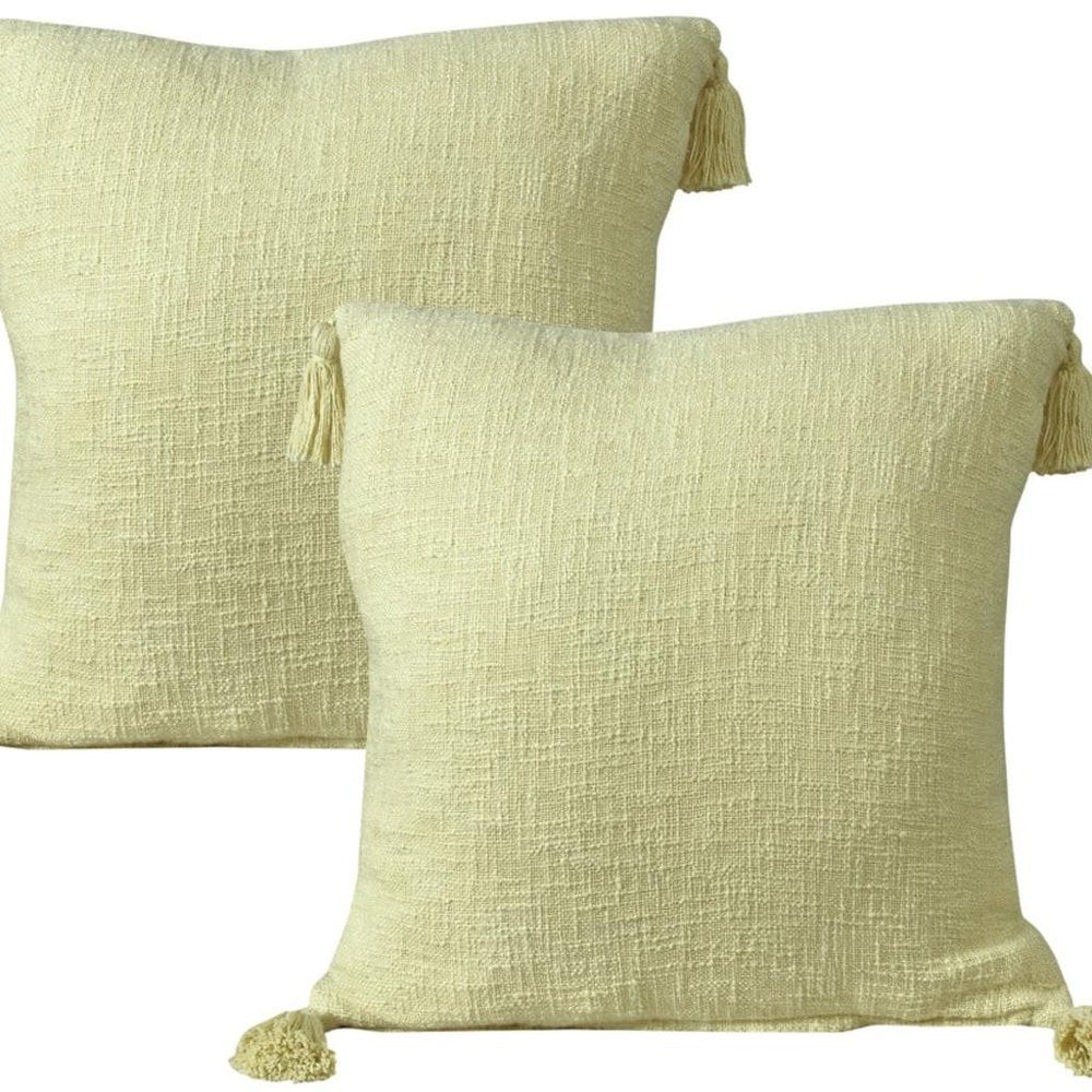 Set of Two 20" Yellow Cotton Throw Pillows with Tassels on a white background