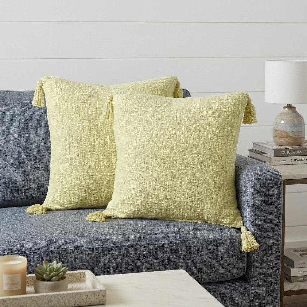 Set of Two 20" Yellow Cotton Throw Pillows with Tassels in a home interior