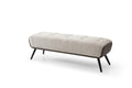 A tufted beige upholstered bench with dark gray faux leather accents and black steel legs on a white background.