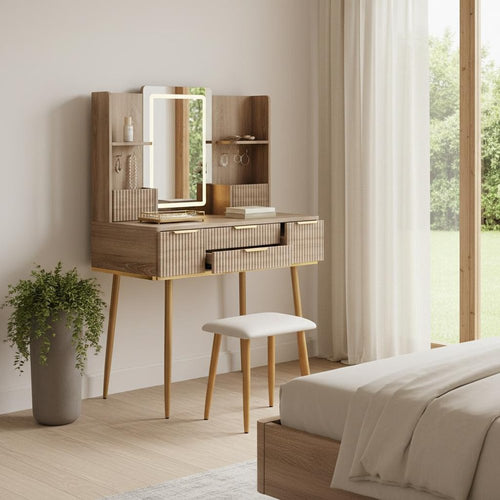 Brown wood vanity table with a lighted mirror, white stool, and plant in a bedroom with a window view.