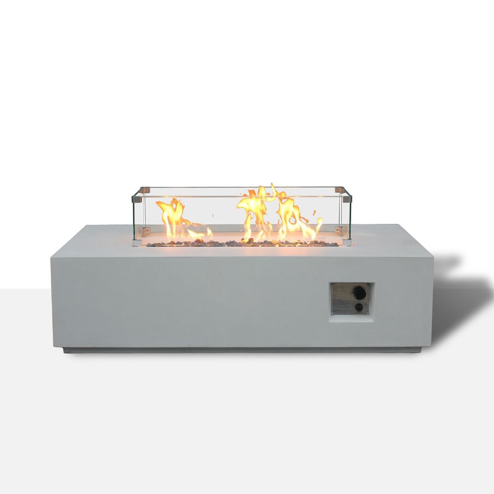 Rectangular concrete propane fire pit in antiqued white with glass wind guard and flames, on a white background.