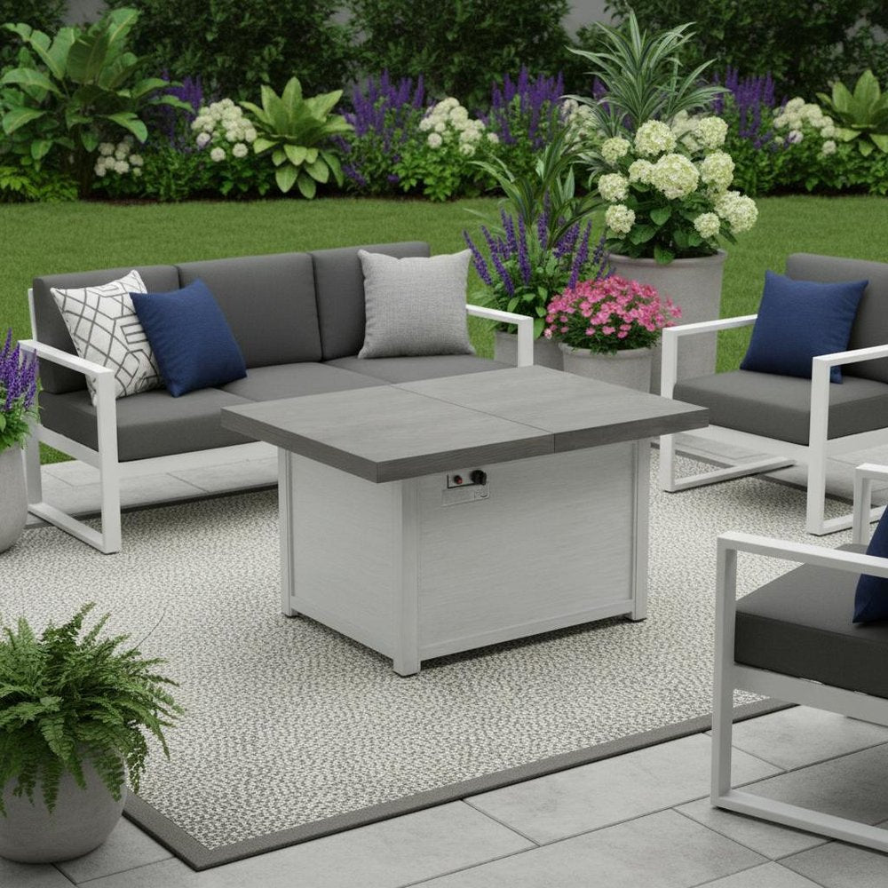 50000 BTU 45" Gray Aluminum Propane Rectangular Fire Pit With Cover shown outdoors on a tiled patio with greenery.
