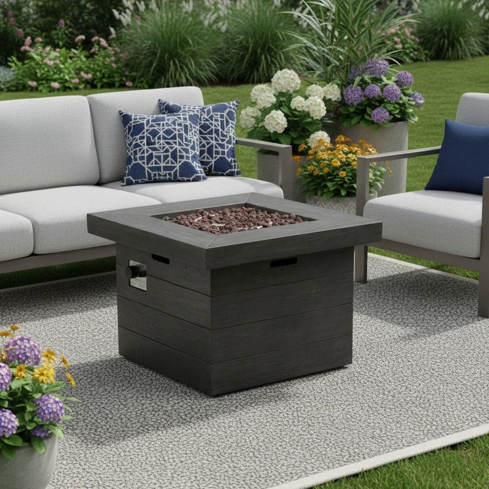 40000 BTU 32" Gray Steel Propane Rectangular Fire Pit With Cover shown outdoors on a tiled patio with greenery.