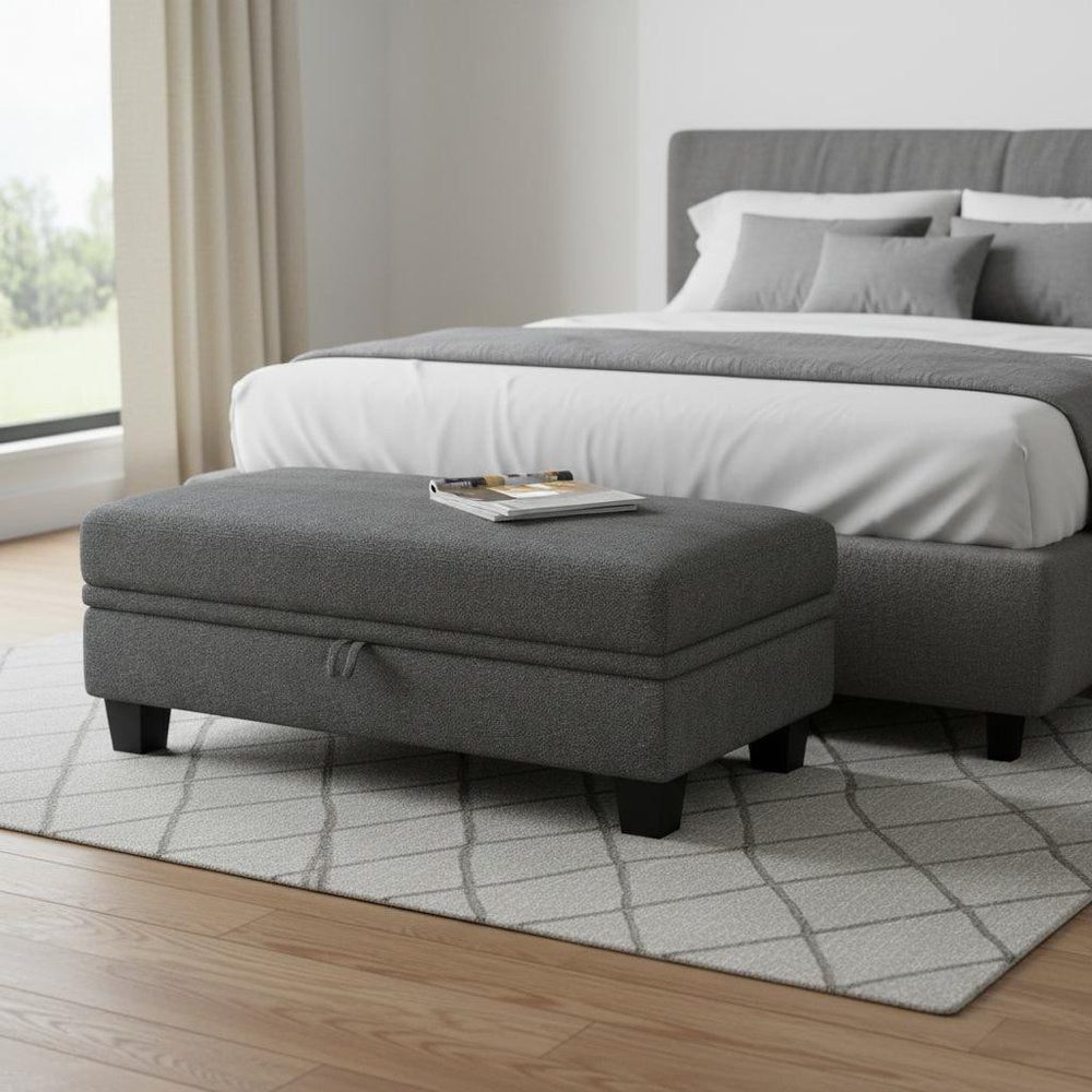 46" Beige And Black Chenille Ottoman With Storage styled in a furnished interior with an off-white wall on a dark wood floor.