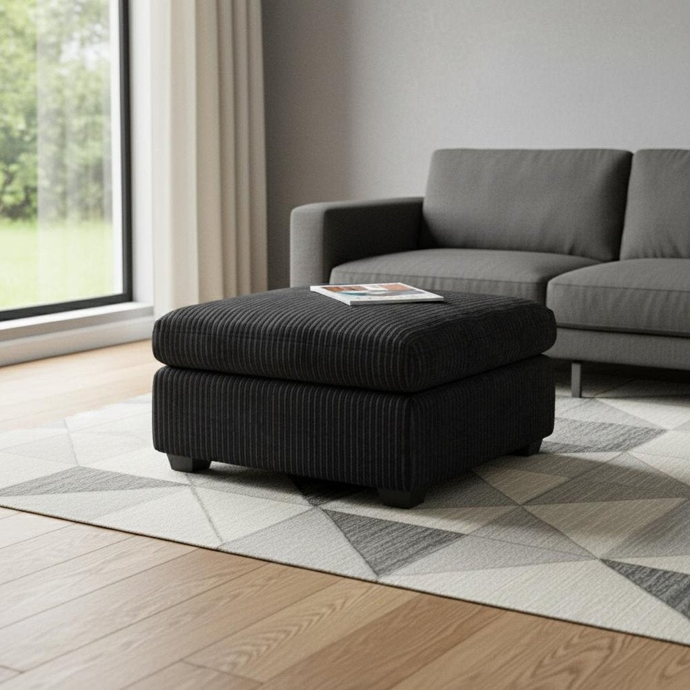 32" Green and Black Corduroy Ottoman styled in a furnished interior with a light gray wall on a wood floor.
