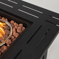 50000 BTU 28" Black Steel Propane Square Fire Pit Table With Cover styled in a furnished interior with a dark wall on a black floor.