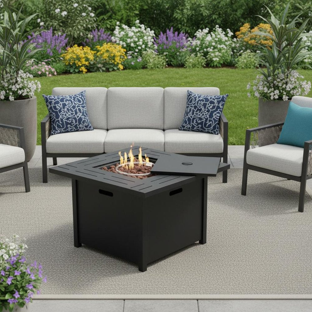 50000 BTU 28" Black Steel Propane Square Fire Pit Table With Cover shown outdoors on a tiled patio with greenery.