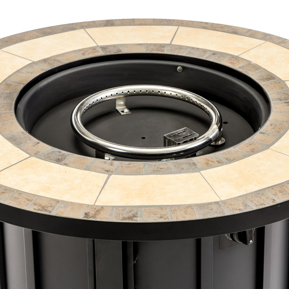 Close-up of a black steel propane fire pit with a tiled rim and a chrome burner ring.