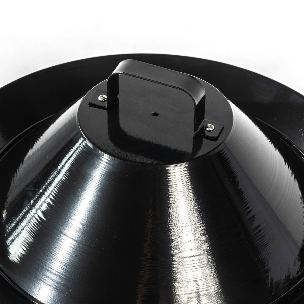 Close-up of a black steel portable tabletop round fire pit with a handle on top, against a white background.