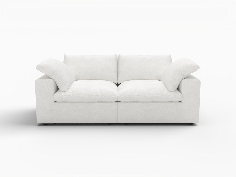White linen blend modular loveseat with toss pillows on a white background.