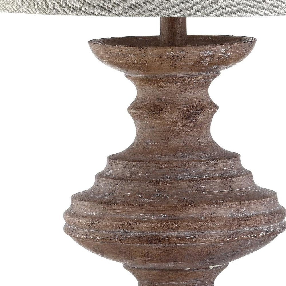 27" Brown Urn Bedside Lamp With Drum Shade. Lamp isolated on a plain white background, finished in brown.