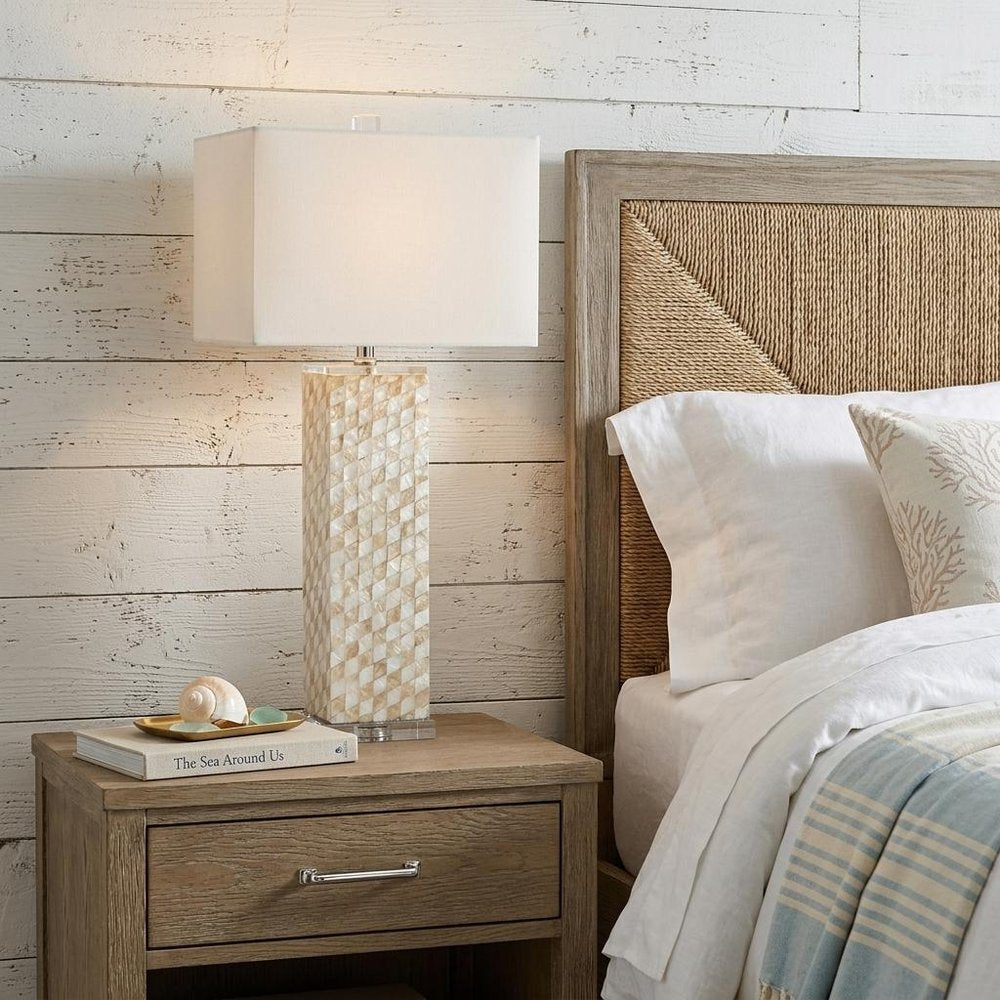 31" Clear Novelty Table Lamp With Shade displayed on a dark wood tabletop in a furnished interior against an off-white wall.